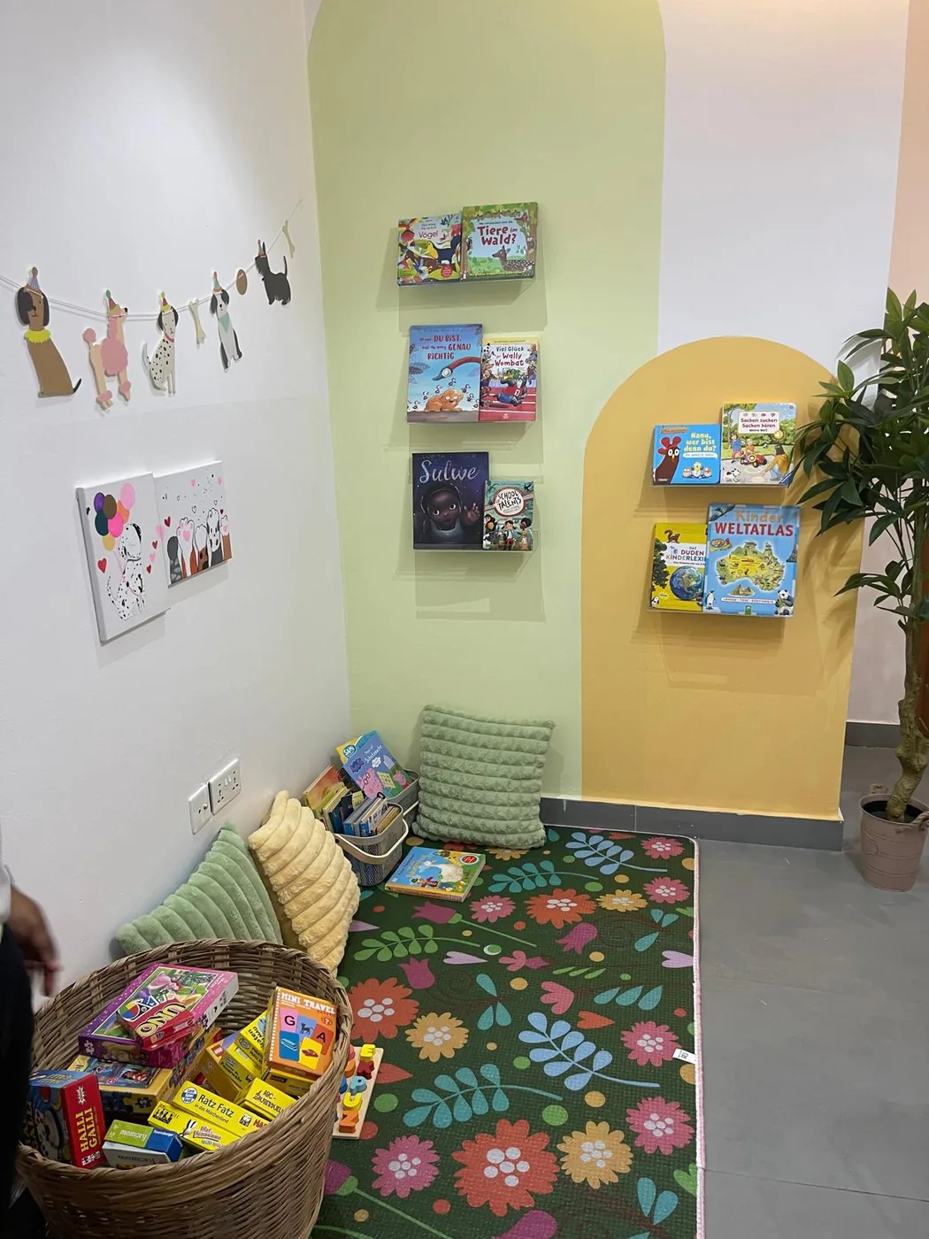 German children's library corner with picture books, cushions and a play rug