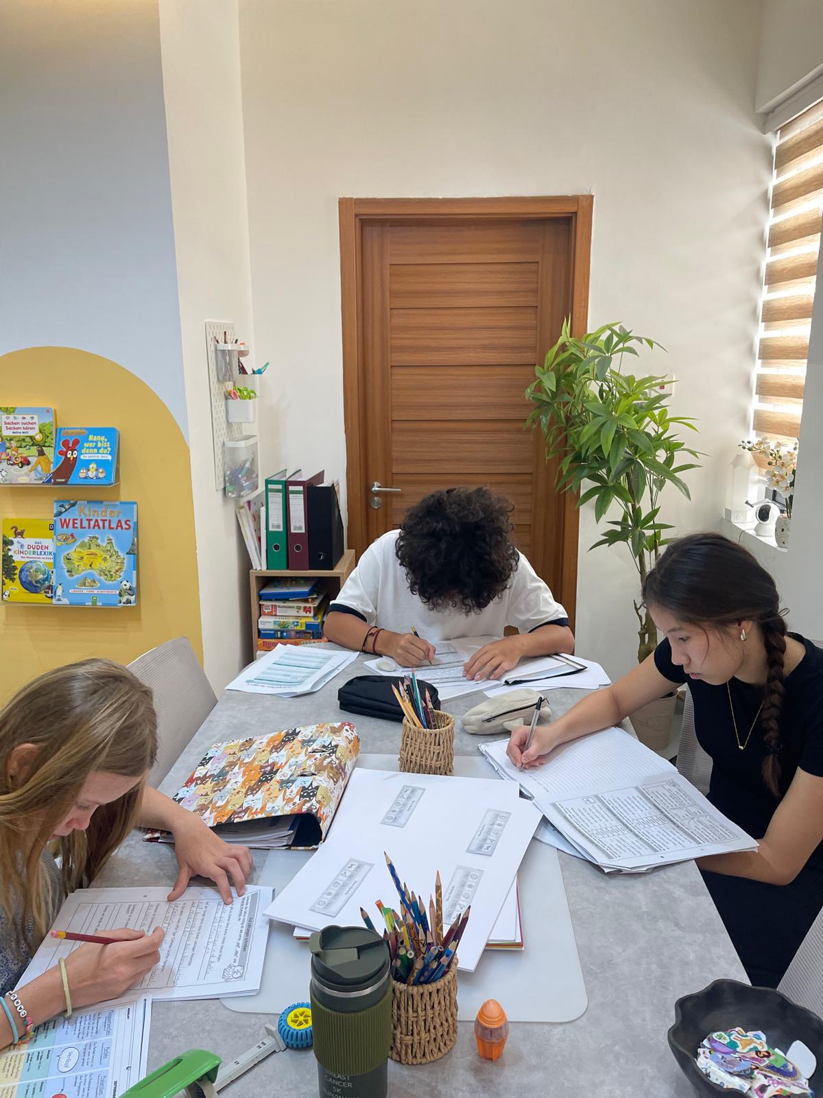 Children and teenagers learning German in a small group at Studyfreunde in Accra