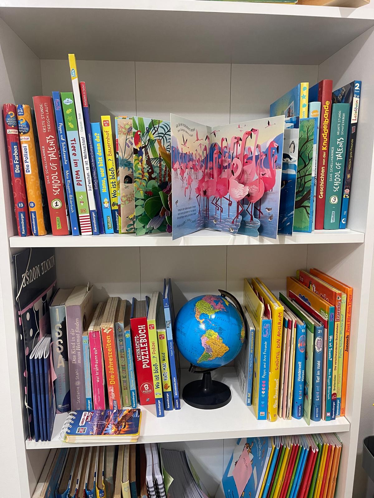Shelf of German children’s books and a globe at the Studyfreunde learning centre in Accra