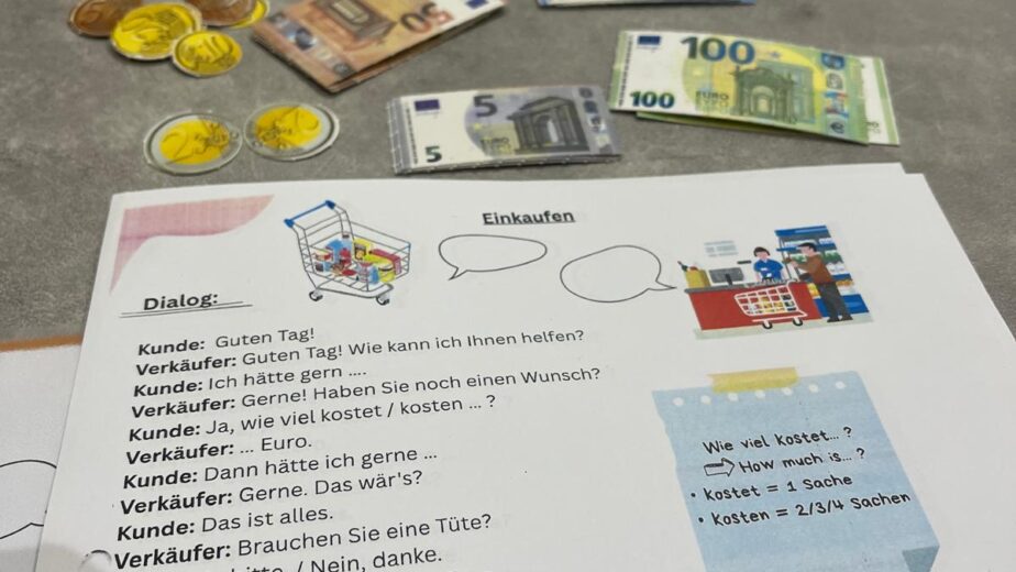 German shopping dialogue worksheet with euro play money, used in A1 lessons for adults in Accra