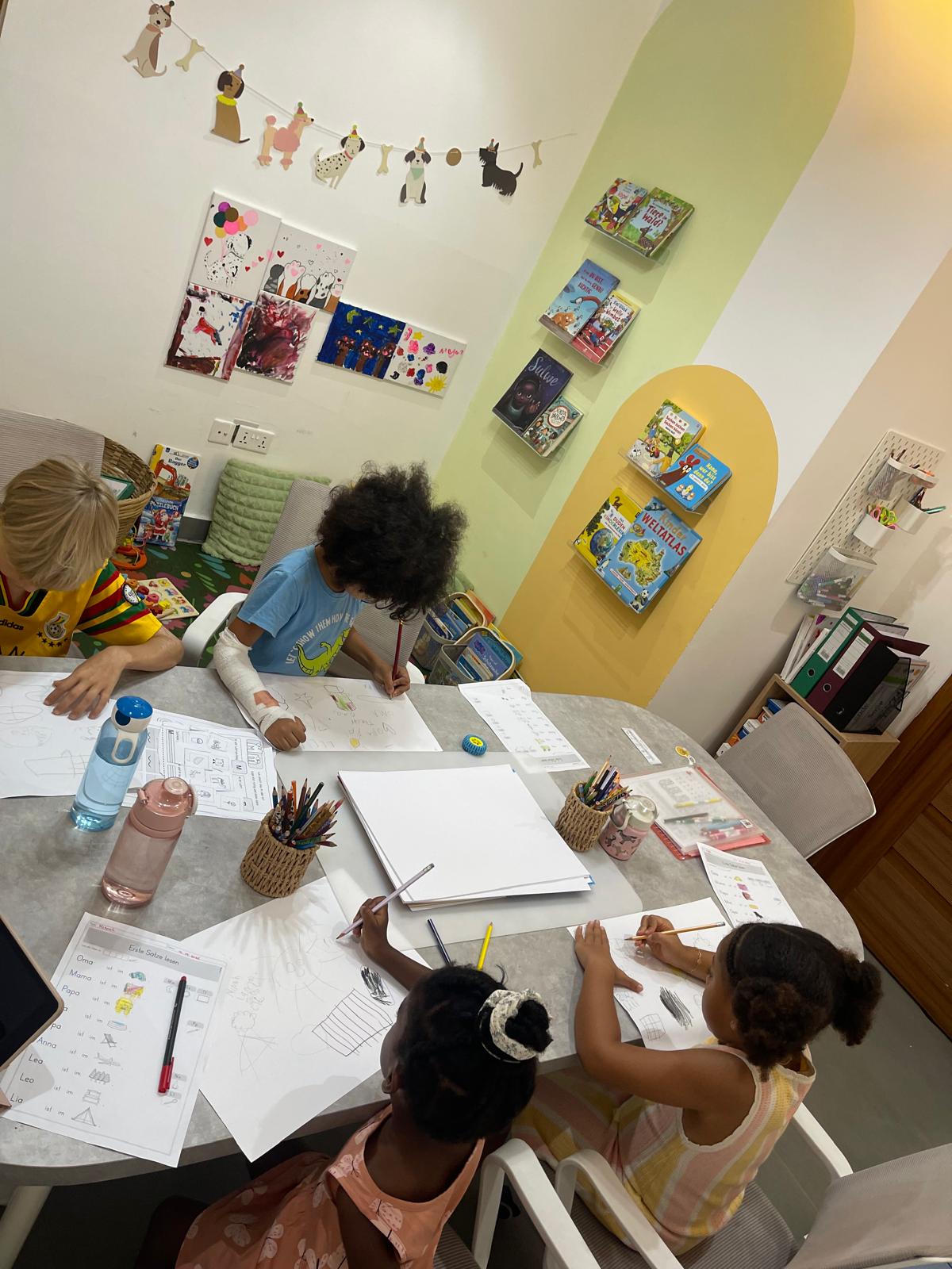 Children writing and drawing in a German lesson for beginners at Studyfreunde in Accra