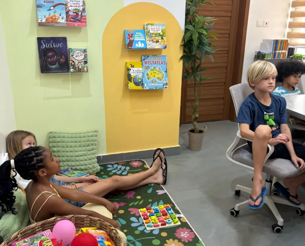 Children reading in the German children's library corner at Studyfreunde in Accra