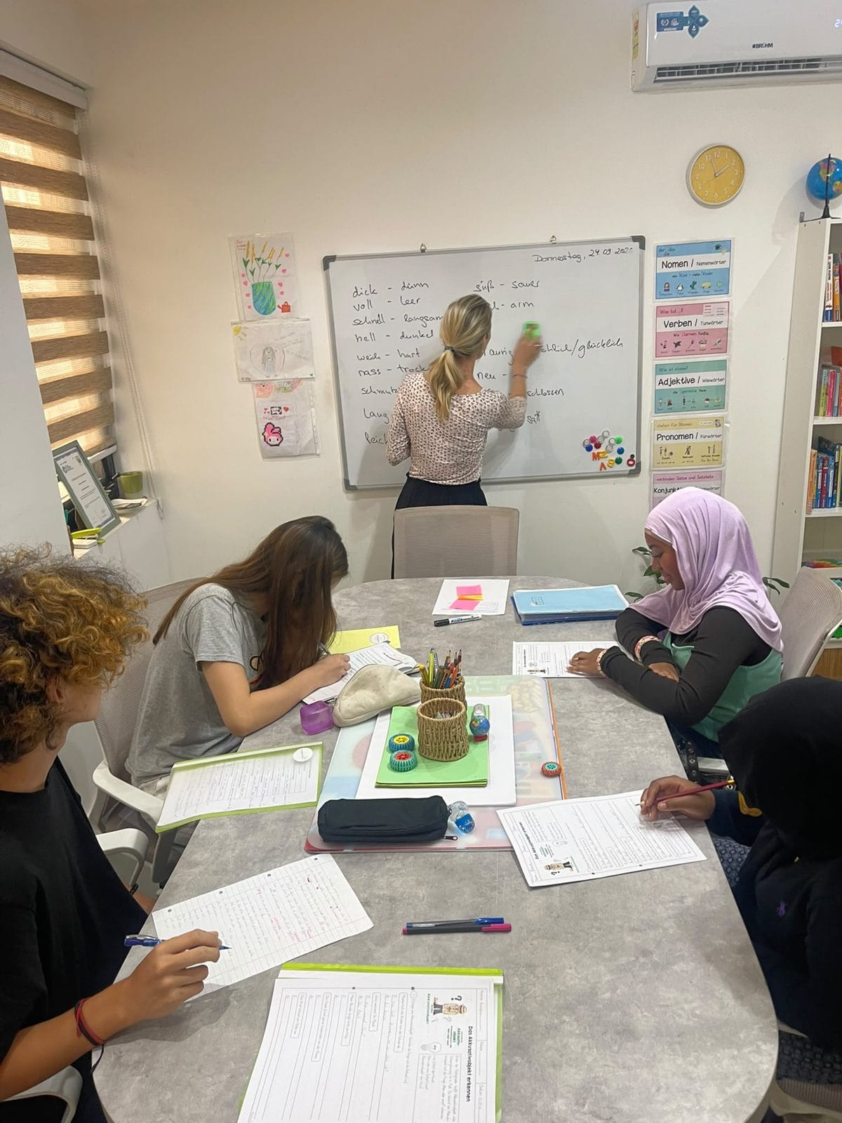 A Studyfreunde teacher at the whiteboard with a group of teenagers in Airport West, Accra
