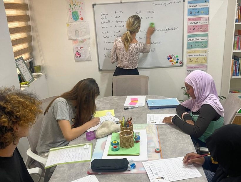 A Studyfreunde teacher at the whiteboard with a group of teenagers in Airport West, Accra